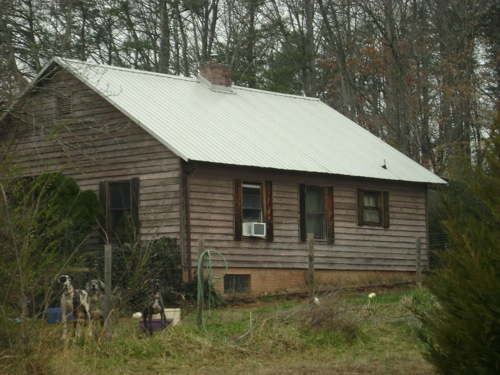 White metal roof on an old wood sided farmhouse, from a Metal Roof Installation job in Berkshire